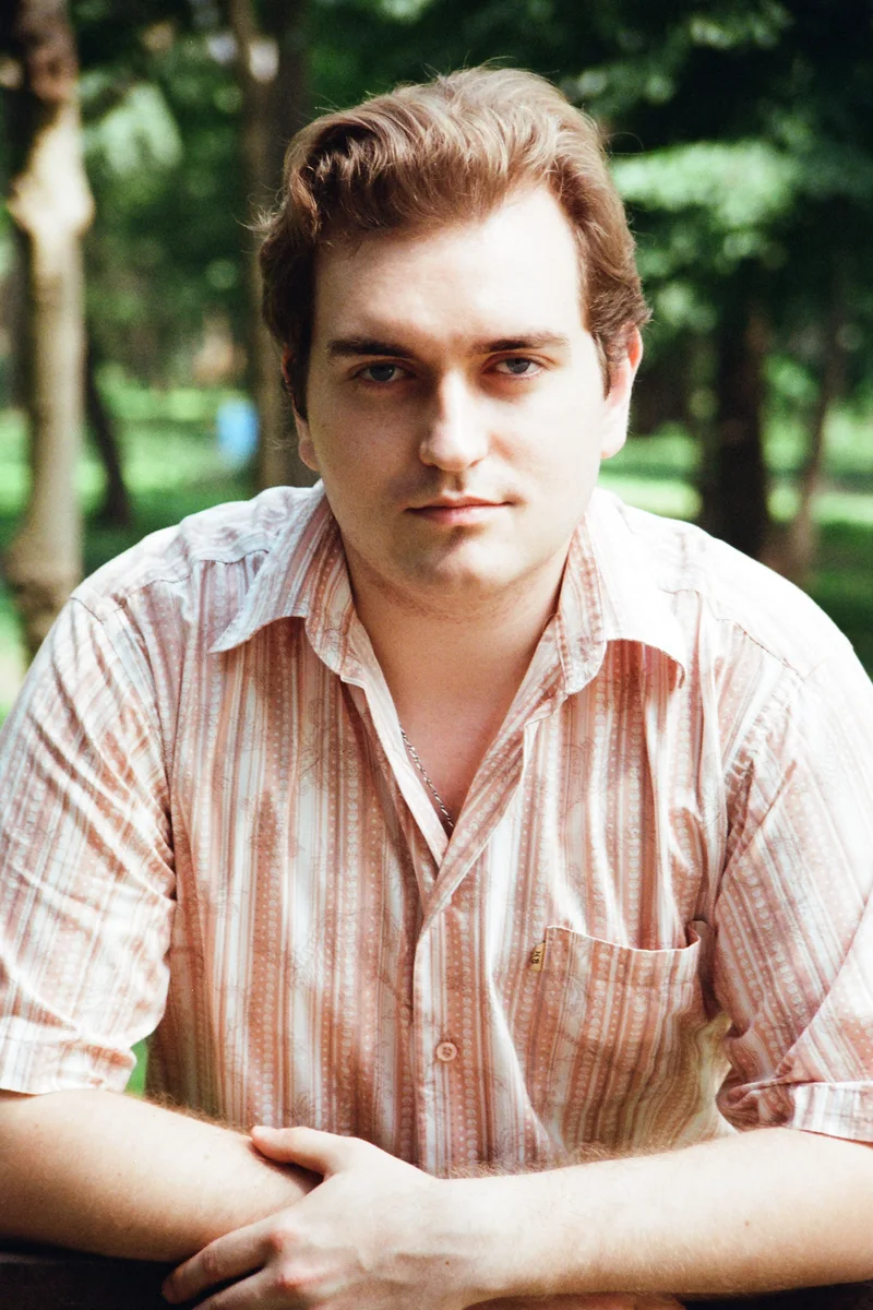 Vladimir Zhivkovich seated outdoors, with his hands resting in front of him.
